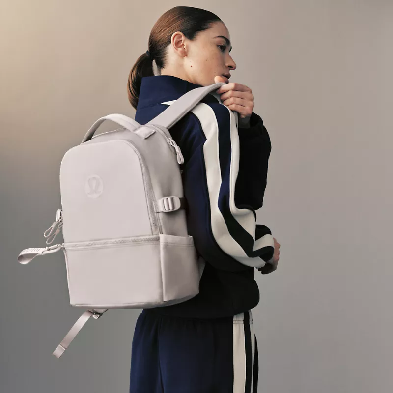 A person carries a New Crew backpack.