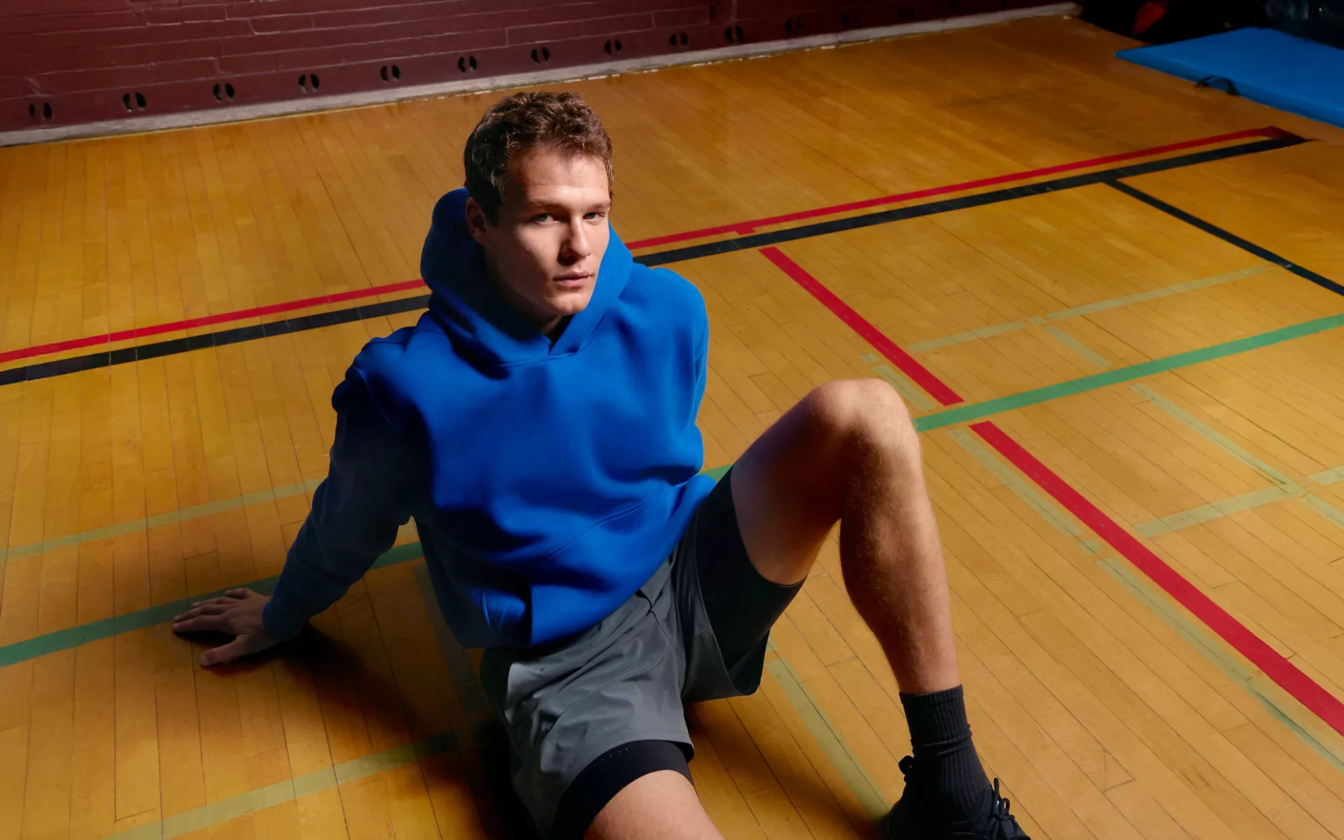 A person wears the new Steady State Pullover Hoodie in SuperLoft™ fleece. 
