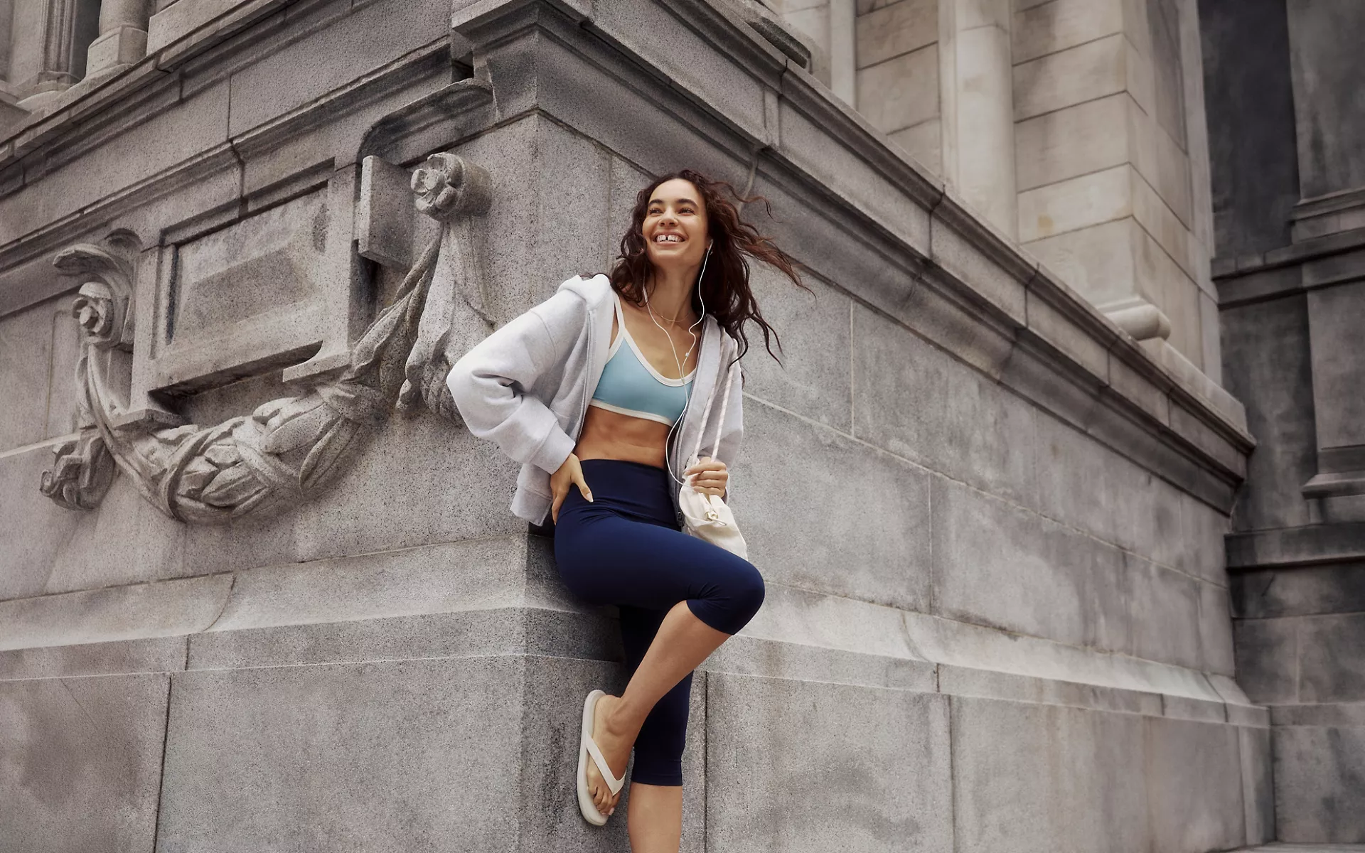 A person wears the lululemon Align No Line™ Crop 17”, UnderEase Cami-Strap Bralette, and Steady State SuperLoft Full-Zip Hoodie.